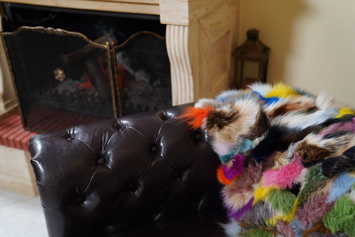 fox fur blanket throw double sided colorful — close-up of the colorful fox fur over the sofa arm by the fireplace — TatiFurs