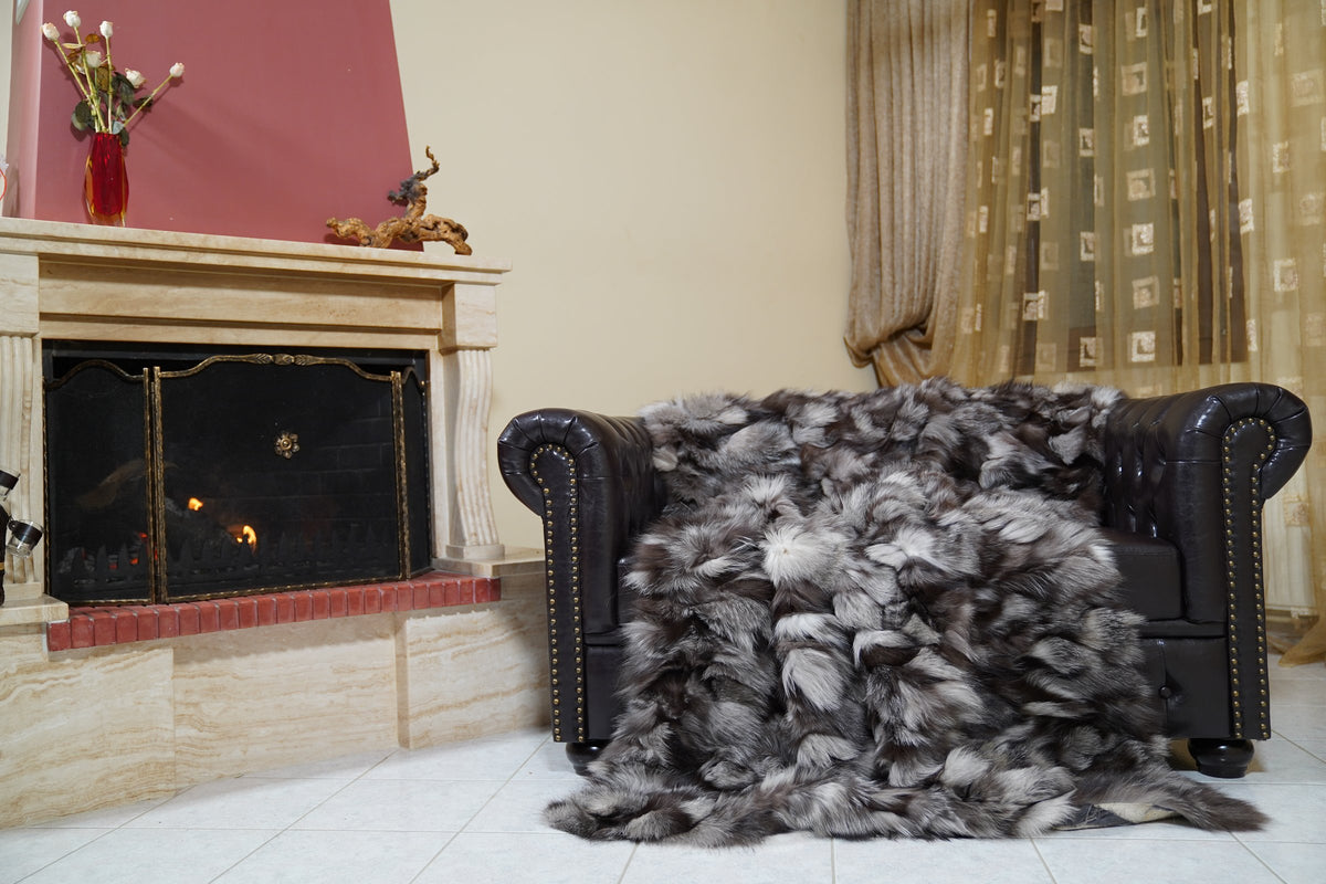 fox fur blanket throw frost natural — draped over the Chesterfield sofa, natural frost fox in silver, brown and black — TatiFurs