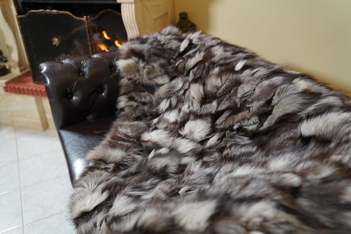 fox fur blanket throw frost natural — detail over the sofa arm, silver tips over brown and black frost fox — TatiFurs