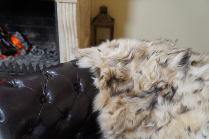 fox fur blanket throw iceberg beige natural — close-up of the natural iceberg beige fox fur by the fireplace — TatiFurs
