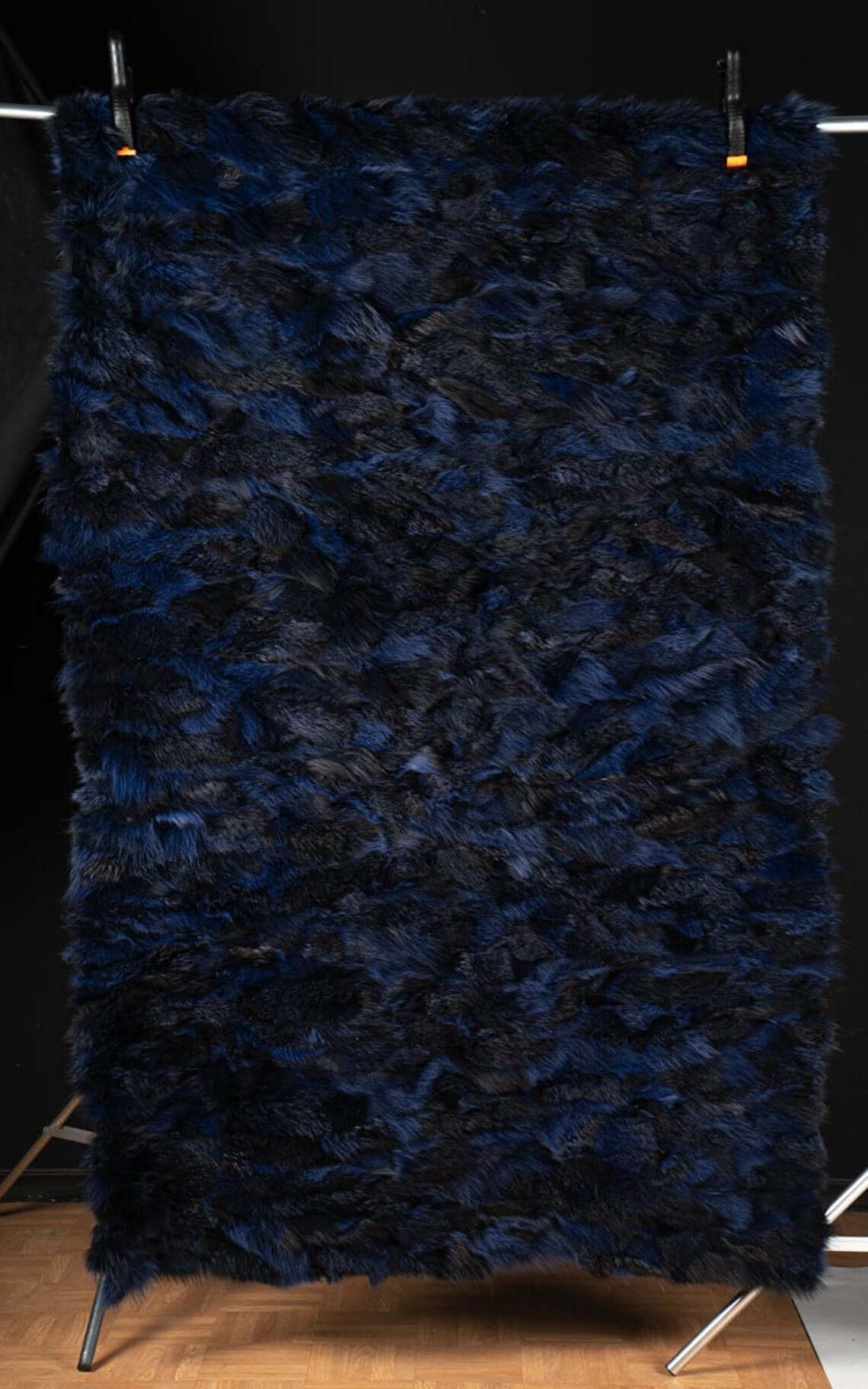 Fox Fur Blanket Throw Blue Electric - Tatifurs displayed against a black background, showcasing its vibrant electric blue and black fur.