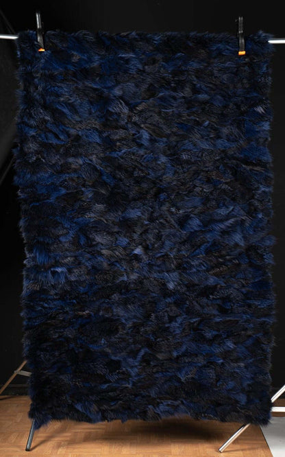 Fox Fur Blanket Throw Blue Electric - Tatifurs displayed against a black background, showcasing its vibrant electric blue and black fur.