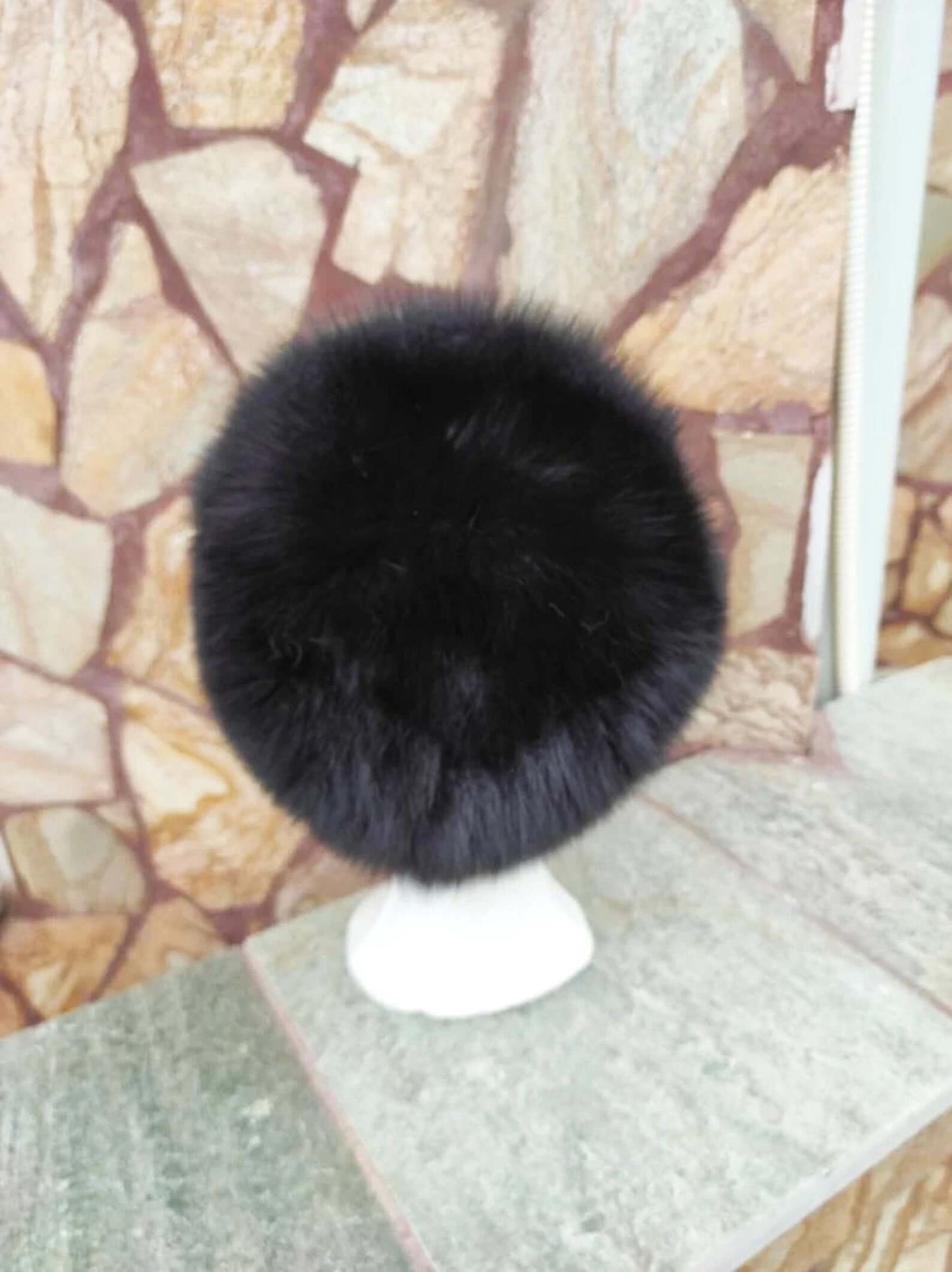 Fox Fur Hat Black - Tatifurs displayed on a stand, showcasing its rich black fur texture.