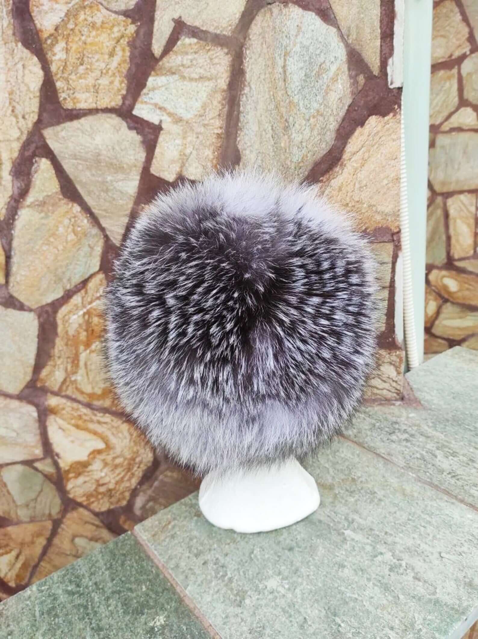 Fox Fur Hat Silver - Tatifurs displayed on a stand, showcasing natural silver fox fur texture and color.