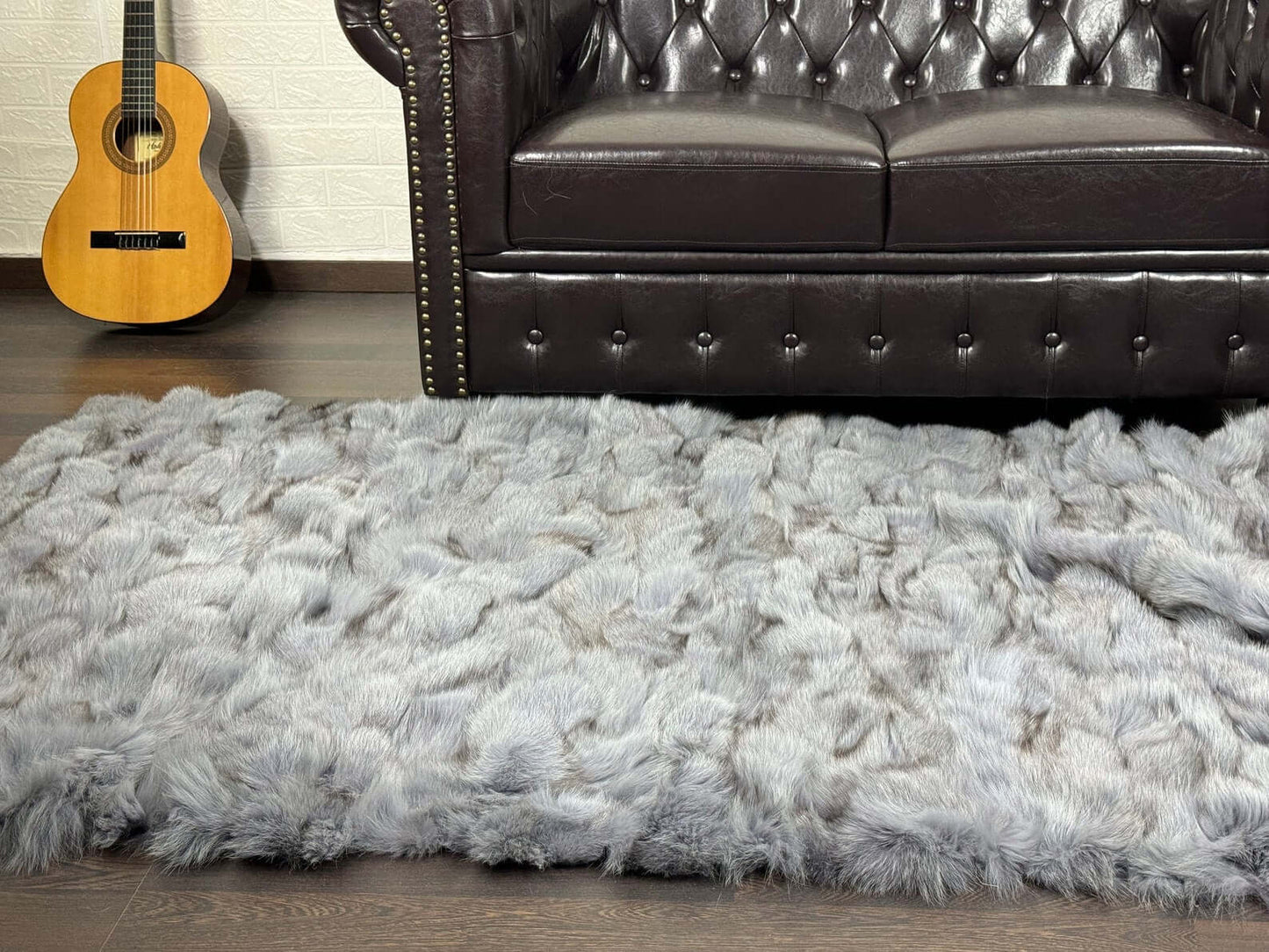 Fox Fur Blanket Throw Bluejean - Tatifurs, luxurious gray fur throw on a stylish sofa.
