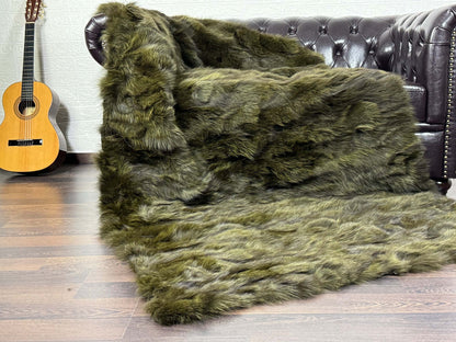 Fox Fur Blanket Throw Green - Tatifurs on a couch, featuring deep, living green hues and long flowing fur pile.