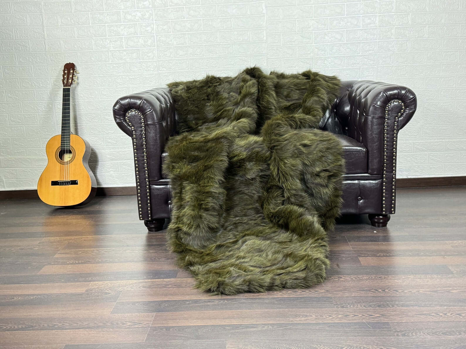 Fox Fur Blanket Throw Green - Tatifurs draped over a chair, showcasing its rich green color and luxurious texture.