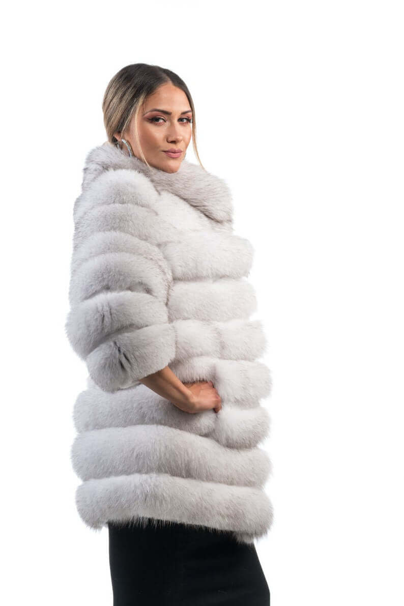 Fox fur coat blue natural shown from the side displaying above knee silhouette and horizontal rabbit trim framed luminous natural blue fox rows — Greek craftsmanship, TatiFurs
