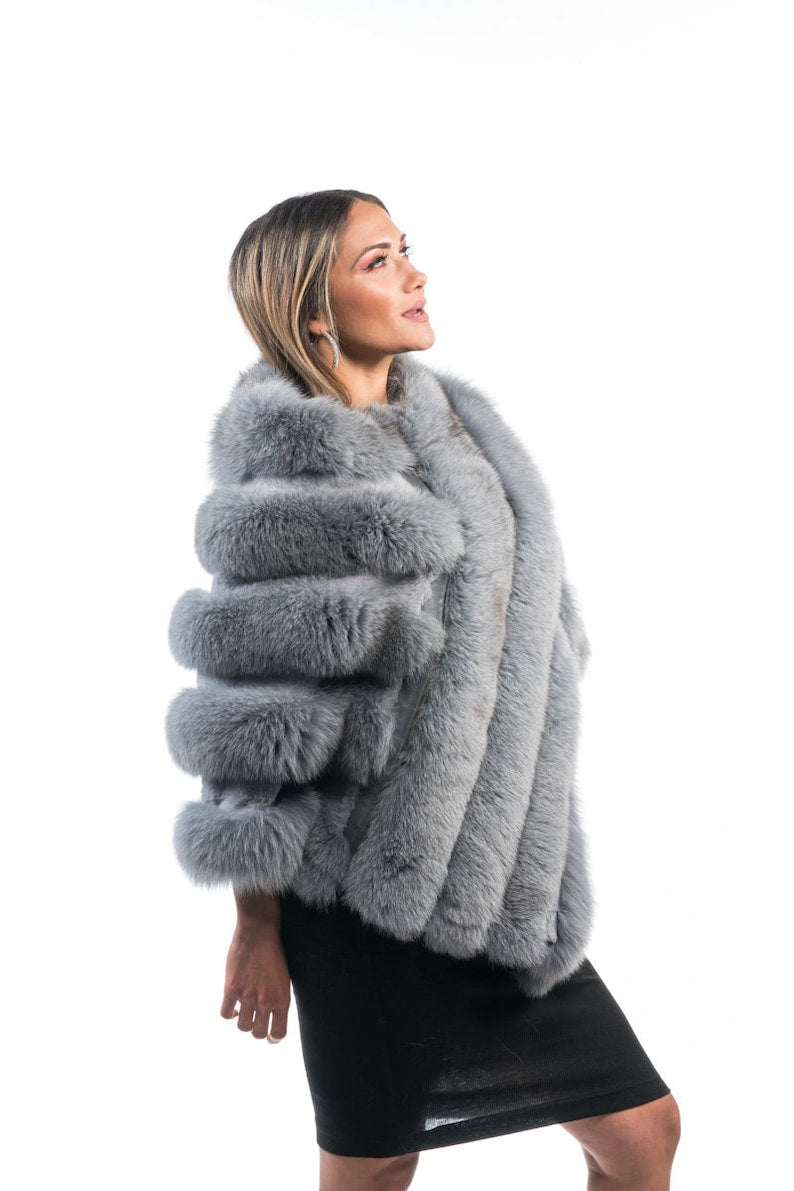 Fox fur poncho gray displaying full skin gray fox diagonal strip construction and hip level poncho silhouette — Greek craftsmanship, TatiFurs
