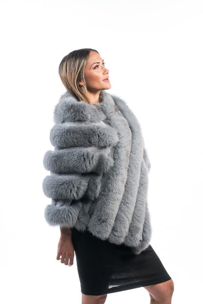 Fox fur poncho gray displaying full skin gray fox diagonal strip construction and hip level poncho silhouette — Greek craftsmanship, TatiFurs
