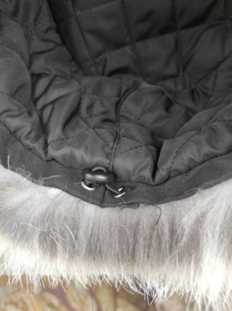 Interior view of the Fox Fur Hat Fuchsia Full Skin - Tatifurs showing adjustable lining and button feature.