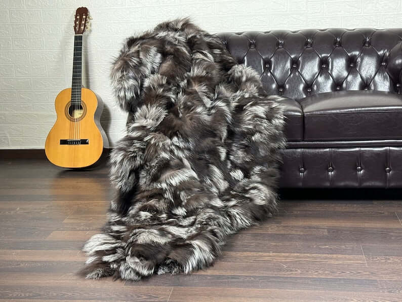 Fox Fur Blanket Throw Double Sided Silver - Tatifurs draped on a couch, showcasing luxurious natural silver fox fur.