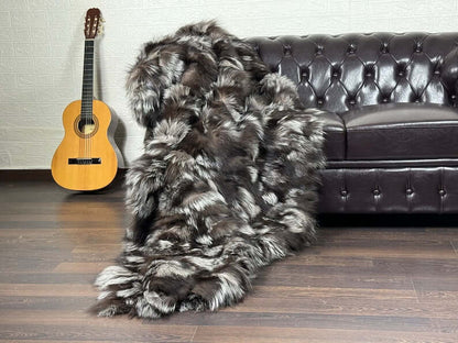Fox Fur Blanket Throw Double Sided Silver - Tatifurs draped on a couch, showcasing luxurious natural silver fox fur.