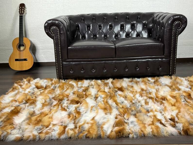 Fox Fur Blanket Throw Red Canadian - Tatifurs displayed on a stylish living room floor with a leather couch.