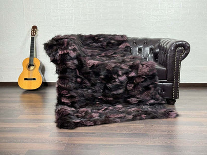 Fox Fur Blanket Throw Black Purple  - Tatifurs draped on a classic leather couch with a guitar.