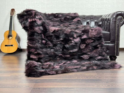 Fox Fur Blanket Throw Black Purple - Tatifurs draped on a sofa, showcasing luxurious black and purple hues.