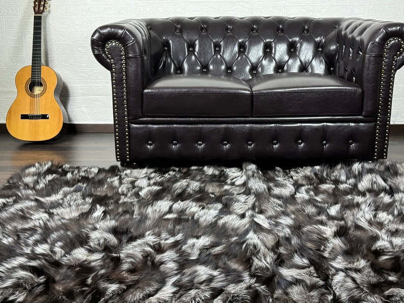 Fox Fur Blanket Throw Silver - Tatifurs displayed on a plush rug in a stylish living room with a guitar.