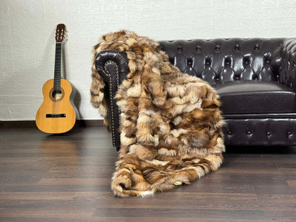 Fox Fur Blanket Throw Crystal Natural - Tatifurs draped over a chair with a guitar nearby in a cozy setting.