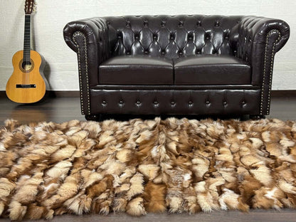 Fox Fur Blanket Throw Crystal Natural - Tatifurs on a floor in front of a brown leather couch with a guitar.