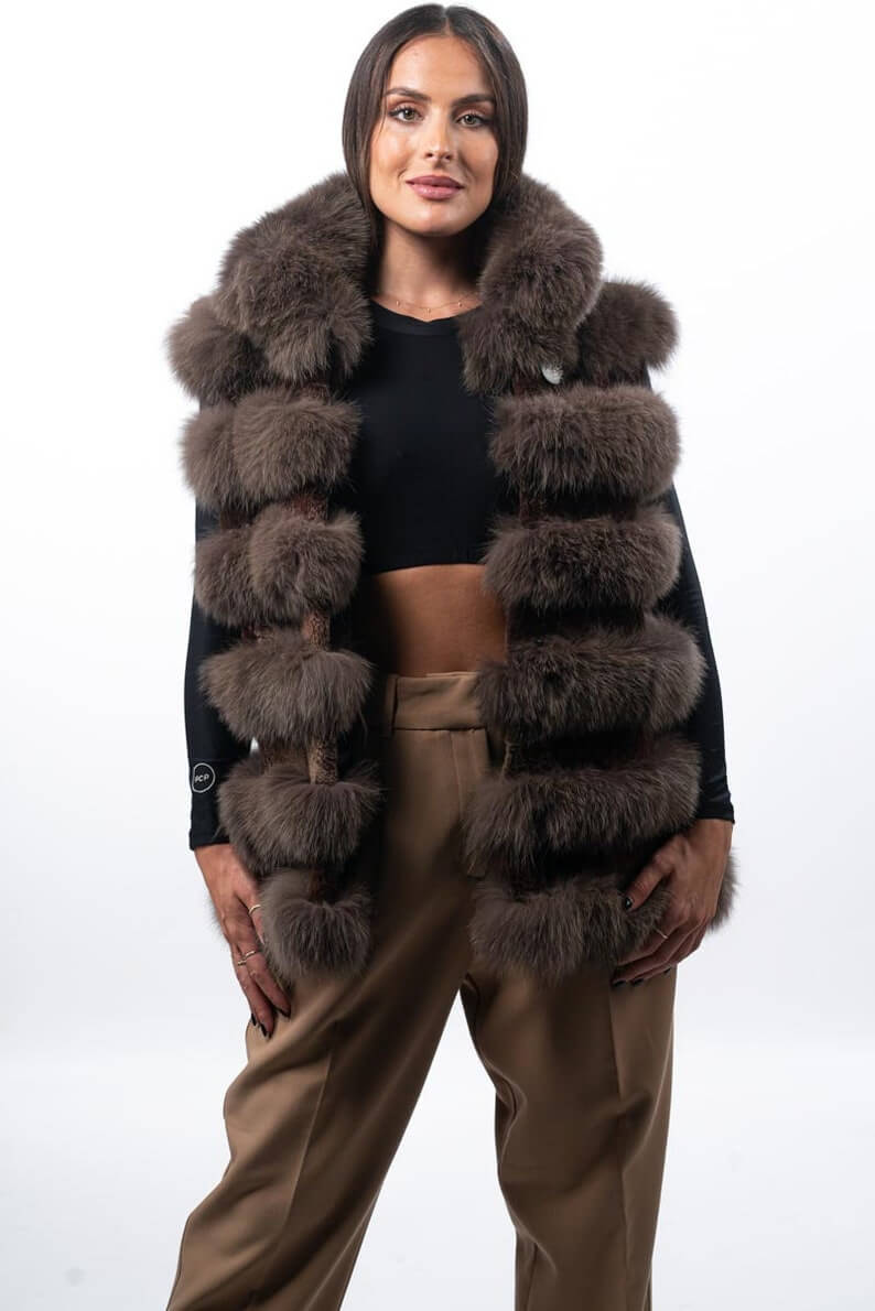 Fox fur vest brown shown from the side displaying hip level silhouette and horizontal rabbit trim framed brown fox rows — Greek craftsmanship, TatiFurs
