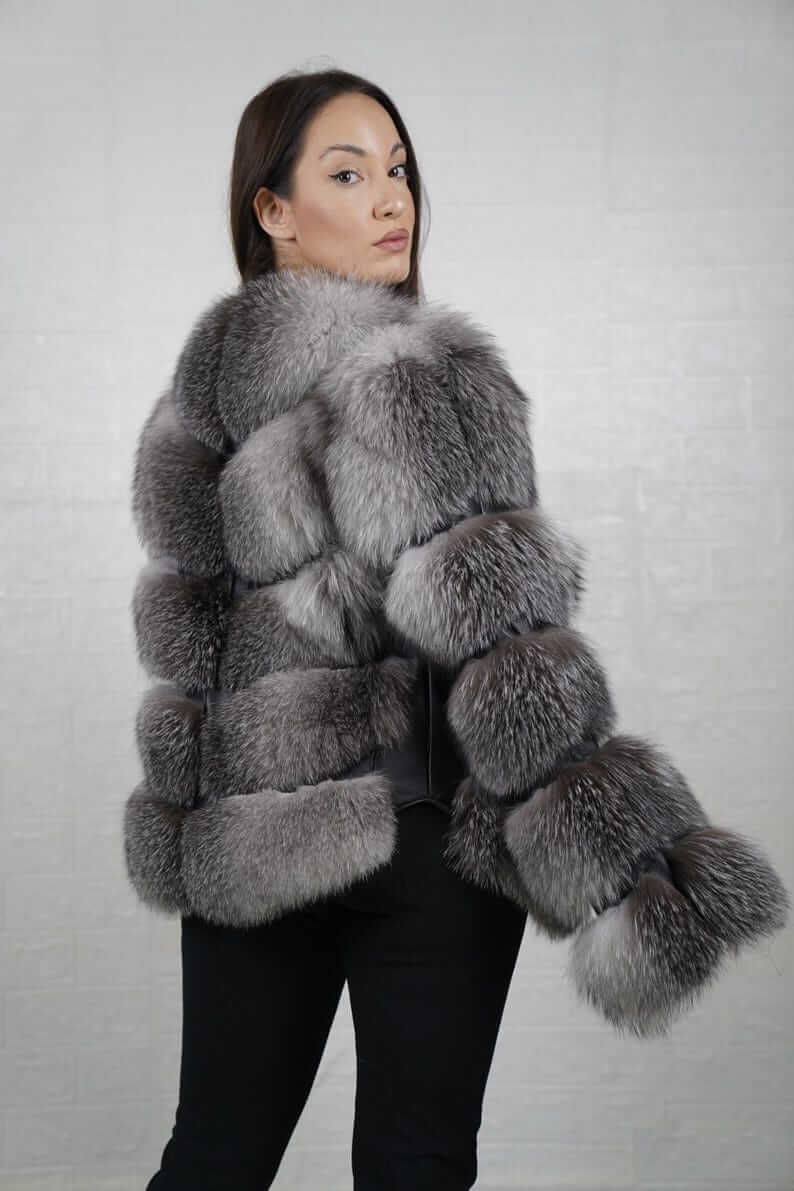 Model wearing frost natural fox fur bomber jacket with leather lines
