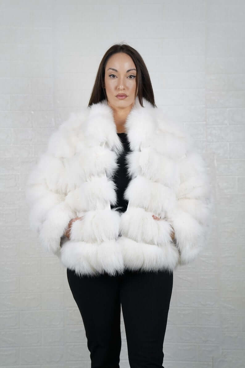 Woman wearing white fox fur short jacket with collar and rabbit fur detail
