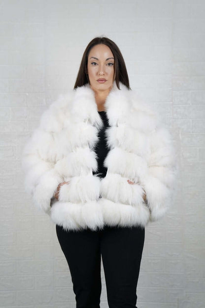 Woman wearing white fox fur short jacket with collar and rabbit fur detail
