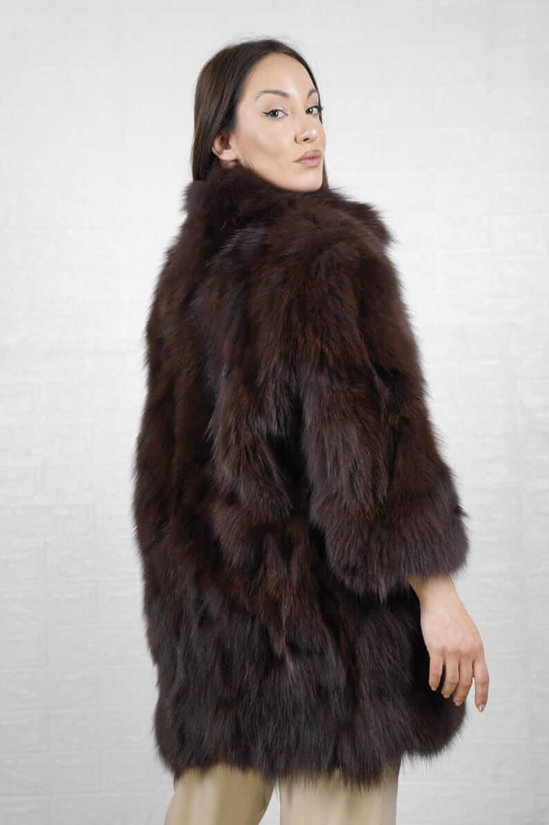 Side profile of brown fox fur jacket showing silhouette and collar
