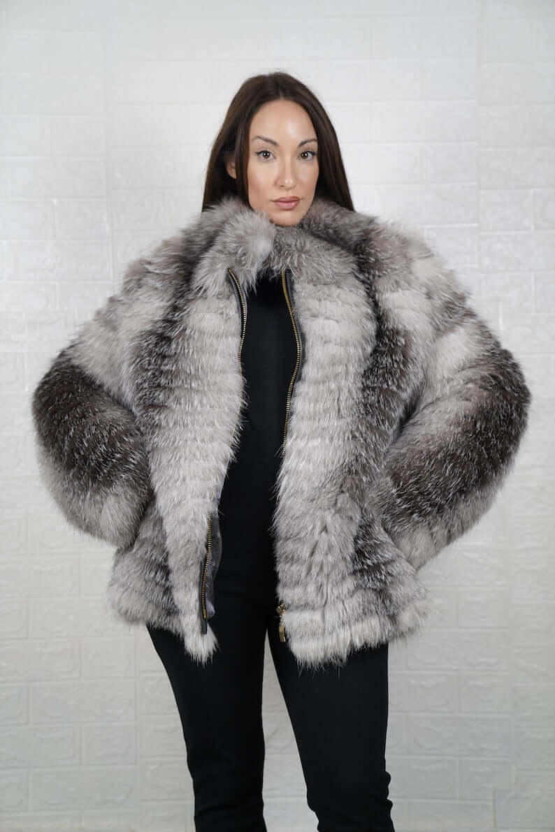 Woman wearing frost fox fur full skin coat with zipper closure and collar

