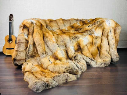 Fox Fur Blanket Throw Gold Saga Fox Natural - Tatifurs displayed on a couch with a guitar nearby.