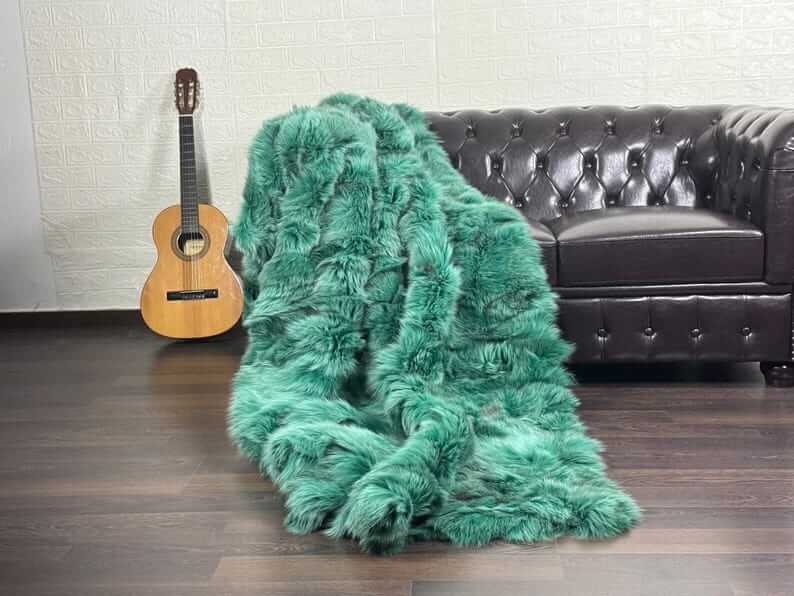 fox fur throw blanket green — draped across cream sofa, green against neutral base — Greek craftsmanship, TatiFurs
