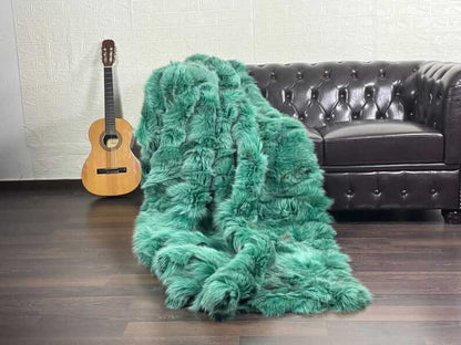 fox fur throw blanket green — draped across cream sofa, green against neutral base — Greek craftsmanship, TatiFurs

