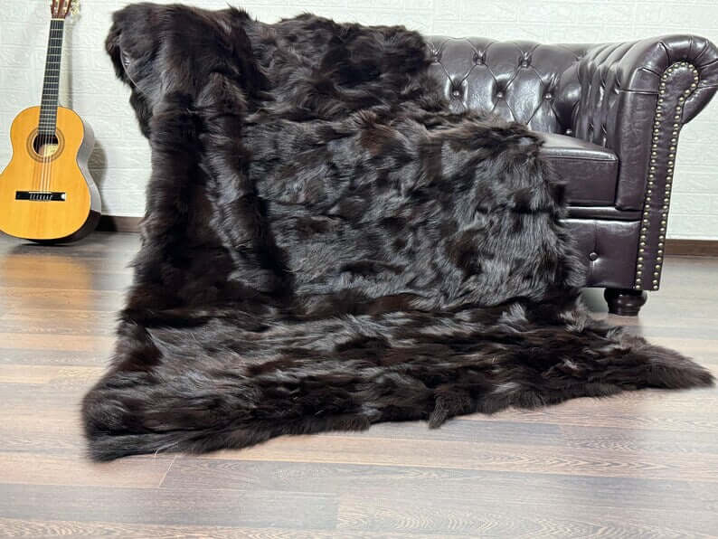 Fox Fur Blanket Throw Brown - Tatifurs draped over a couch, showcasing its rich brown color and luxurious texture.