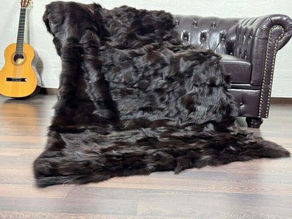Fox Fur Blanket Throw Brown - Tatifurs draped over a couch, showcasing its rich brown color and luxurious texture.