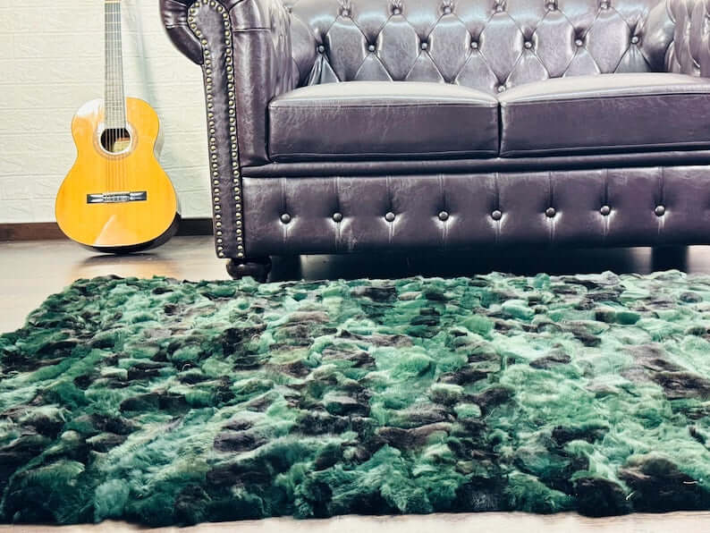 Rabbit Blanket Throw Rex Green Black - Tatifurs displayed on a plush rug next to a stylish guitar and a leather sofa.