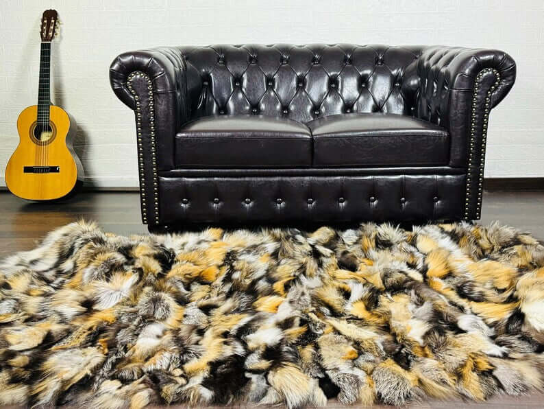 Fox Fur Blanket Throw Double Sided Gross Natural draped on floor in front of luxurious leather sofa.