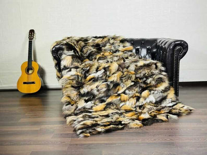 Fox Fur Blanket Throw Double Sided Gross Natural displayed on a couch with an acoustic guitar nearby.