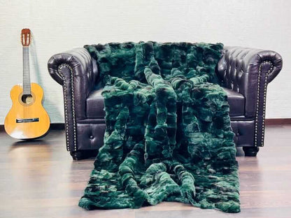 Rabbit Blanket Throw Rex Green Black - Tatifurs draped on a leather couch with an acoustic guitar.