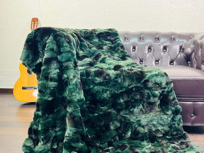 Rabbit Blanket Throw Rex Green Black - Tatifurs draped on a couch with a guitar in the background.