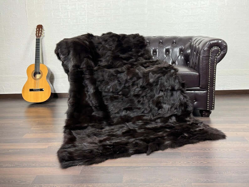 Fox Fur Blanket Throw Brown - Tatifurs draped over a couch in a stylish setting, showcasing its luxurious texture.