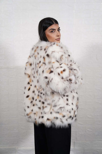 Side profile of white fox fur coat showing silhouette and leopard collar
