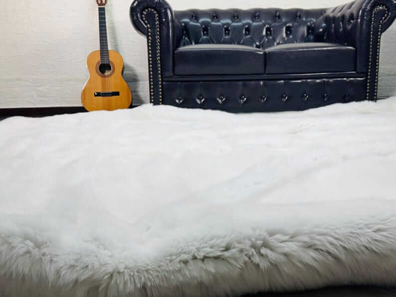 White Fox Fur Throw Blanket - Tatifurs displayed elegantly in a cozy living room setting.