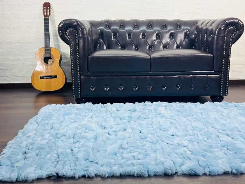 rex rabbit fur throw blanket light blue — draped across white sofa, airy soft blue contrast — Greek craftsmanship, TatiFurs
