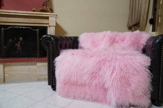 Pink fluffy sheepskin mongolian throw blanket in a room with a fireplace
