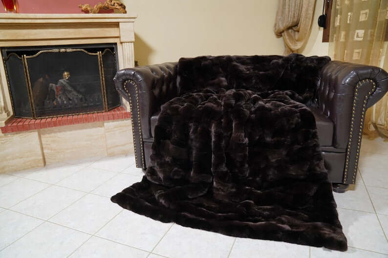 Rabbit Blanket Throw Rex Dark Brown - Tatifurs draped elegantly over a stylish sofa in a cozy living room.
