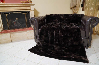 Rabbit Blanket Throw Rex Dark Brown - Tatifurs draped elegantly over a stylish sofa in a cozy living room.