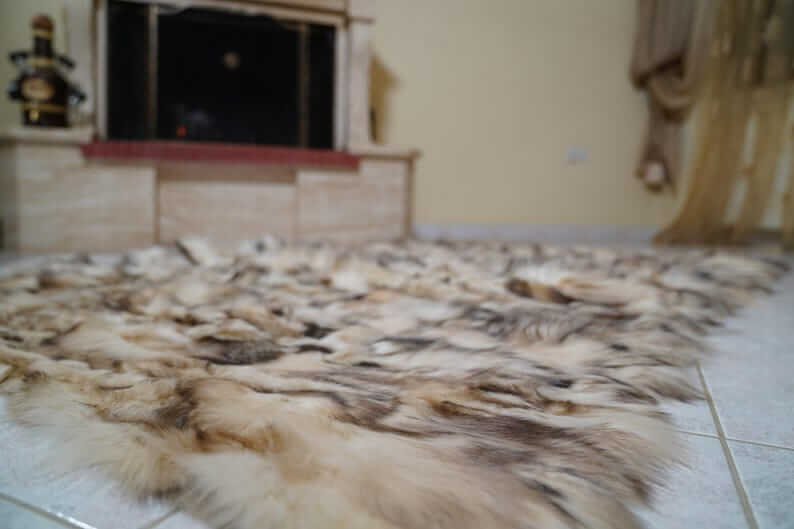 Fox Fur Blanket Throw Double Sided Iceberg Beige on the floor near a fireplace.