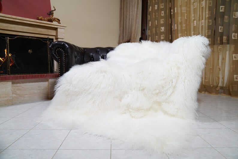 White Wool Sheepskin Mongolian Blanket Throw - Tatifurs draped elegantly over a stylish sofa, showcasing its luxurious texture.