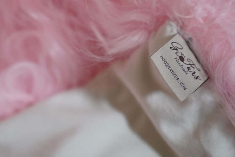 Wool Sheepskin Mongolian Blanket Throw Pink - Tatifurs label detail showing softness and quality.