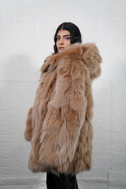 Person wearing a fur coat against a white textured wall